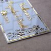 Rectangular white and gold nameplate with floral design, customizable name option.