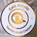 qalb acrylic logo and tagline on round acrylic signboard made using gold and white acrylic sheet