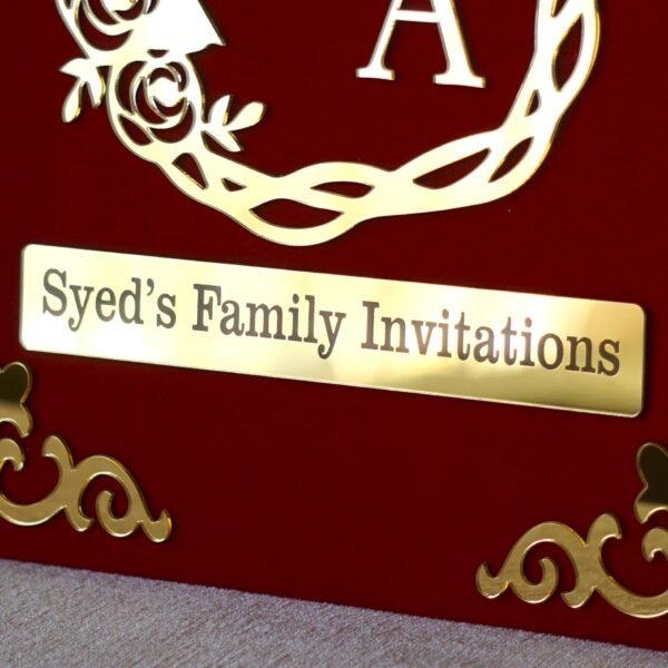 Nikah Invitation Booklet Made using red velvet and golden acrylic, the size of the product is 14 by 12 inches.