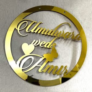 Golden round wall hanging with couple's name. Acrylic and MDF.