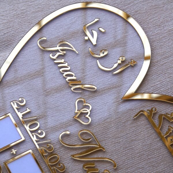 1740235490001 personalized wedding thumb board in heart-shaped design with floral embellishments, this nikah thumb board is made using golden and transparent acrylic sheets. It is used as a wedding keepsake that can be showcased on a cabinet.