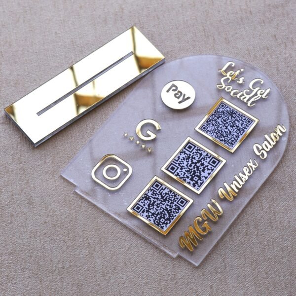 1740235489315 A customizable QR code stand made using imported acrylic and golden sheets is perfect for business desks and exhibitions. The QR codes and brand name can be customized. The stand is removable, and the size of the product is 5 by 7 inches.