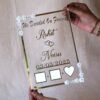 Transparent & silver acrylic personalized wedding thumbprint frame with floral corner embellishments, embossed bride and groom names and date, plus dedicated thumbprint spaces.