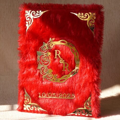 A red fur–clad nikah nama booklet with an acrylic cover and MDF backing, opened to blank pages for the bride’s and groom’s thumbprints and signatures as a lasting wedding keepsake